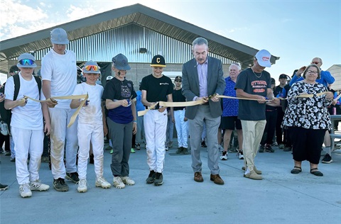 An image of the ribbon cutting for the Dutcher Baseball Complex.